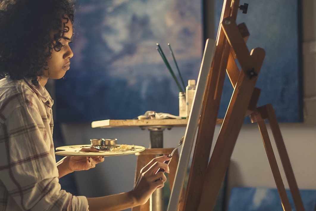 Young Black woman painting image